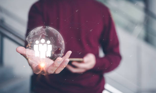 istock teamwork team leader HRM or Human Resource Management, businessman holding virtual glob with icon in concept of human development team recruitment leadership and customer target group concept. 1473224584