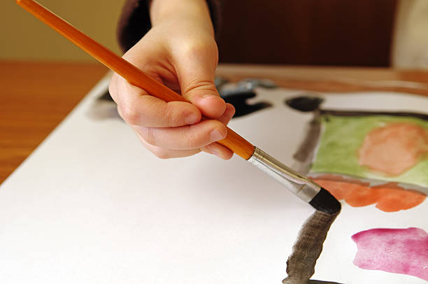 istock Six years old boy painting 147322581