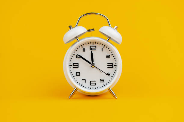 istock white clock on yellow background concept of time time is important to work 1473227369