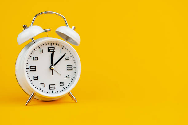 istock white clock on yellow background concept of time time is important to work 1473227416