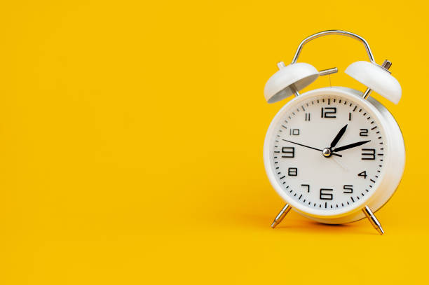 istock white clock on yellow background concept of time time is important to work 1473227421