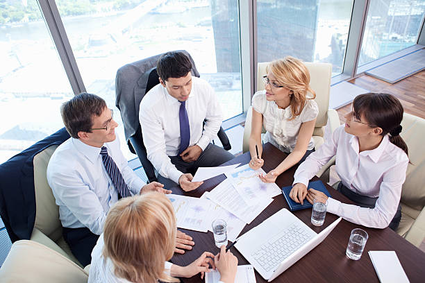 istock Five business people having a meeting at a conference table 147322747