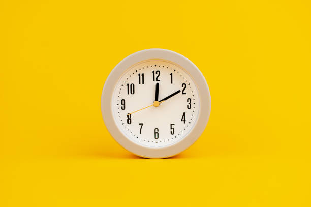 istock white clock on yellow background concept of time time is important to work 1473227579