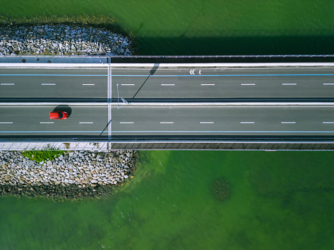 A red car cruises on the newly built Cebu Cordova Link Expressway (CCLEX) or popular called the 