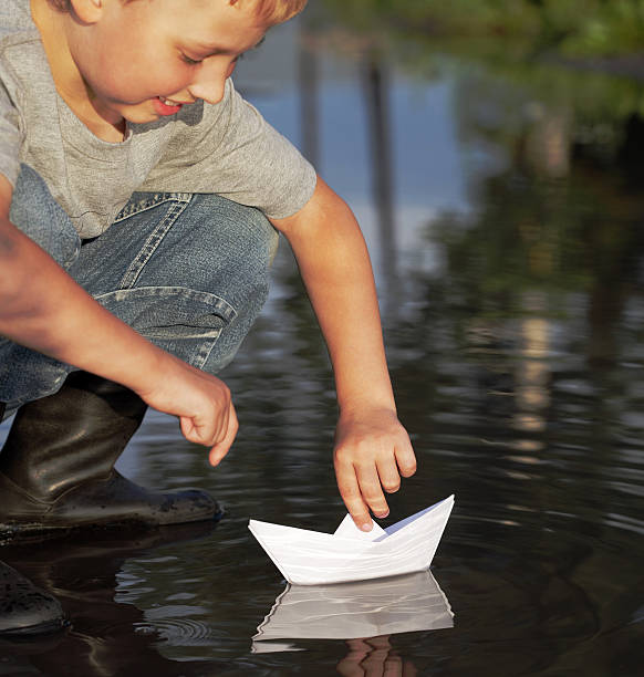 istock paper ship in children hand 147322882
