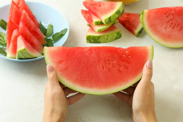 istock Female hands hold watermelon slice, close up 1473229513