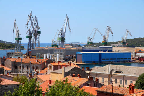 Croatia - Pula on Istria peninsula. Contemporary seaport, industrial cargo cranes.