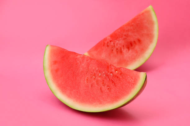 istock Juicy watermelon slices on pink background, close up 1473230260