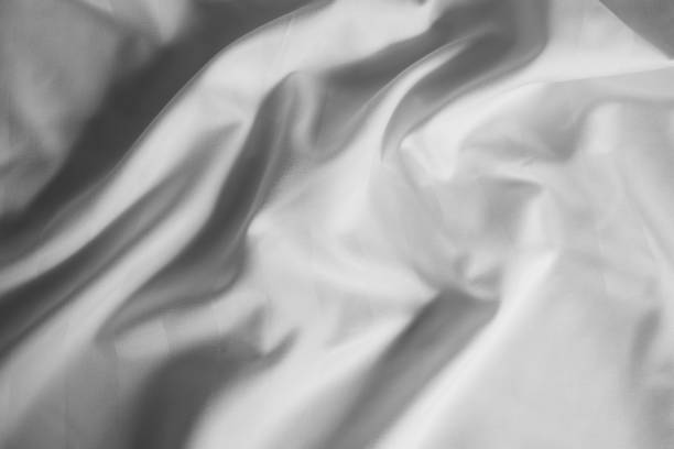 istock Light grey abstract background, satin texture, wavy fabric folds 1473230901