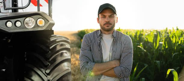 istock Farmer with digital tablet on a background of harvester. 1473234506