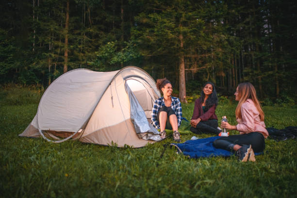 istock Female Backpackers  Having Fun in Front of a Tent 1473234585