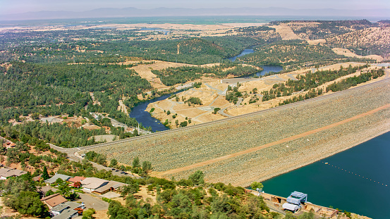 Aerial view of Oroville Dam on Lake Oroville during sunny day, Oroville, California, USA.