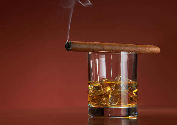 istock Whiskey with ice cubes and cigar, on brown 147323684
