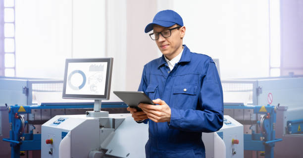 istock Engineer uses a digital tablet to control robots in a smart factory. 1473237043