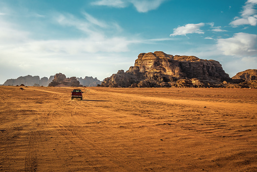 An off-road vehicle in a beautiful and savage desert landscapes north of Tabuk in Saudi Arabia