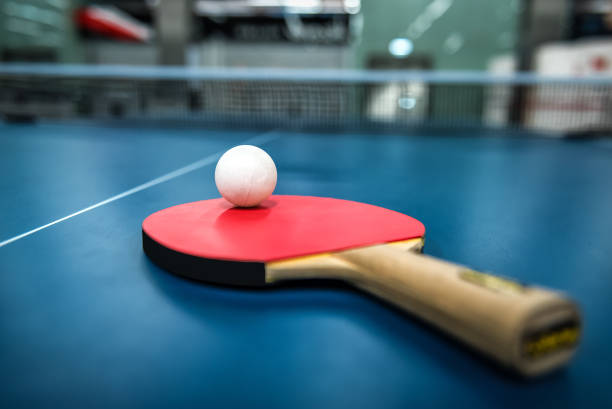 istock Ping pong table, racket and ball in a sport hall 1473237684