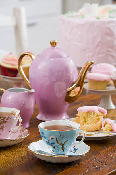 istock tea set on a wooden table with cake and cupcakes 147323848