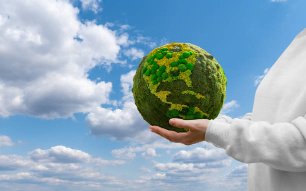 istock Woman holds a green planet Earth. 1473238787