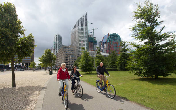 The Hague, Holland - June 18, 2011: People cycle through central The Hague, Holland, on June 18, 2011. The Hague is the capital city of the Netherlands
