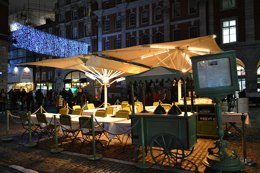 London, UK - November 27, 2013: Night view of the outdoor seating of a Covent Garden cafe \