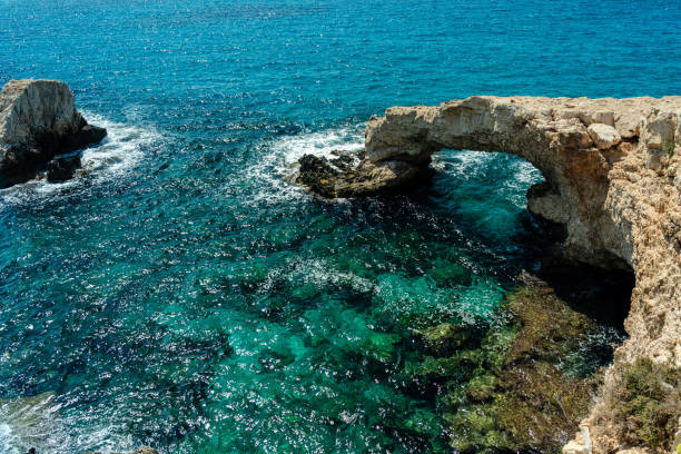 istock Azure sea around beautiful rocky arch 1473243313