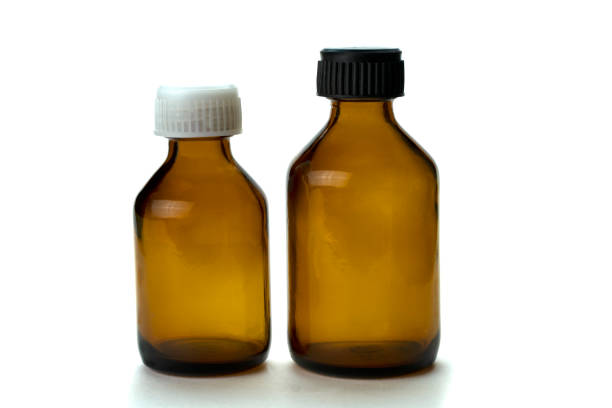 istock Medical medicine bottle with black cap isolated on white background. 1473243570