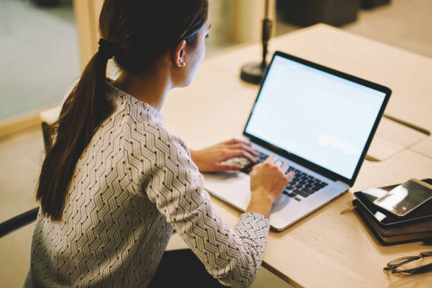 istock Unrecognizable female looking at screen and typing 1473245009