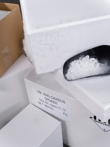 boxes with black scoop containing dry ice