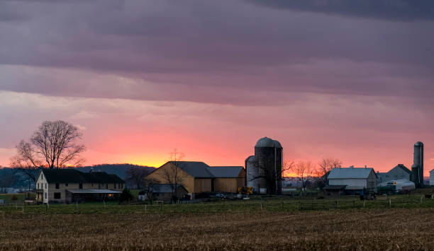 istock View of a Sunset, Trying to Break Thru Clouds, With Multiple Cloud Layers, and Red Sun 1473246368