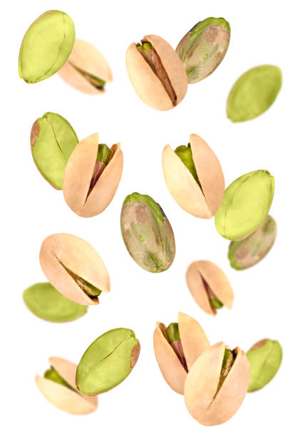 istock Levitation of pistachios isolated on a white background. 1473248984