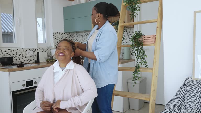 Daughter making her mother's hair at home