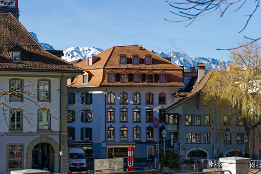 Facades of historic houses at alley at the old town of Swiss City of Thun on a sunny winter day. Photo taken February 21st, 2023, Thun, Switzerland.