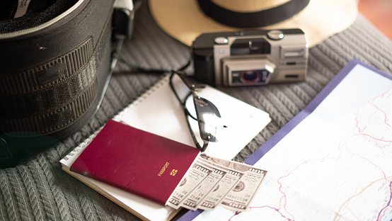 Vacation suitcase and vacation equipment lying on the bed