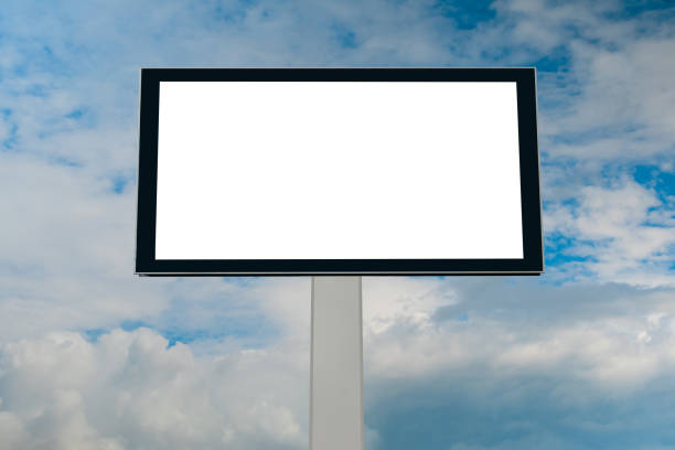 istock Mock up - blank white billboard against blue sky with white clouds 1473256152