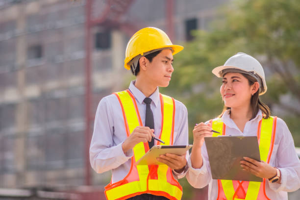 istock Male and female Engineer standing talking about construction project background 1473256258