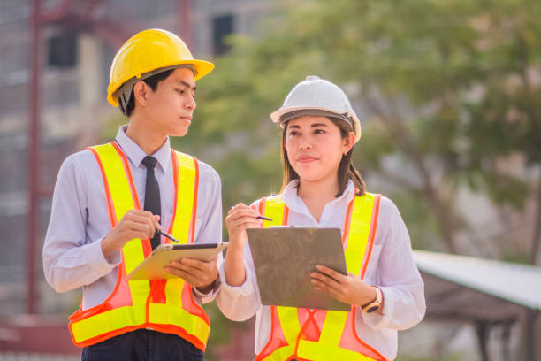 istock Male and female Engineer standing talking about construction project background 1473256260