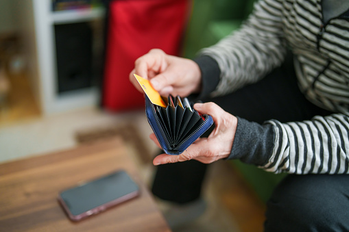 Senior woman making online shopping with her credit card on mobile phone