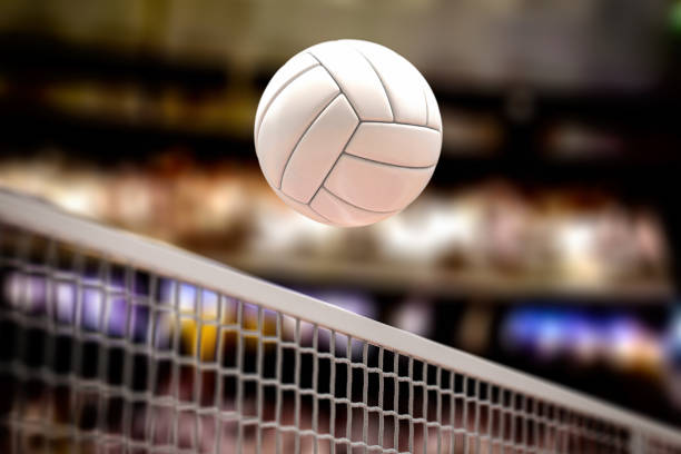 Volleyball ball and net in voleyball arena during a match. stock photo