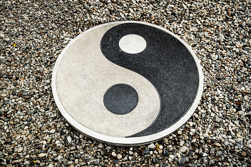 Yin Yang symbol on natural water stones background