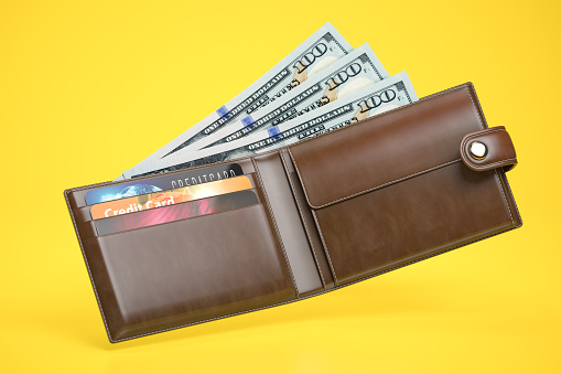Open leather wallet with dollars and credit cards on yellow background. 3d illustration