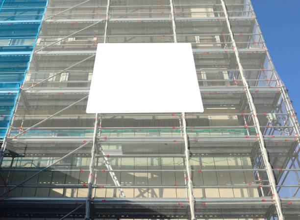istock Blank information board on a facade under refurbishment.The building is covered with a transparent scaffold sheeting. 1473260772