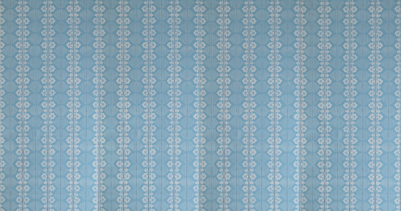 Old wallpaper on the wall. Old wallpaper for texture or background.