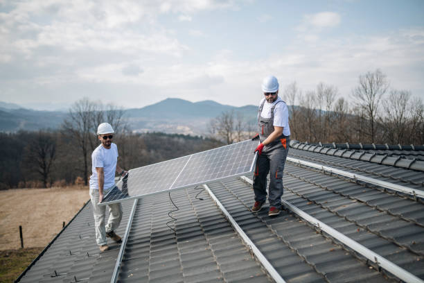 istock Caucasian men installing panels on roof. 1473263757