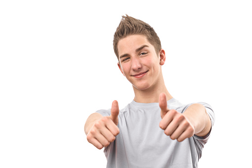 Happy teenage boy showing thumb up