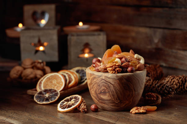 istock Dried fruits and assorted nuts on a wooden table. 1473265391