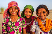 istock Three happy Gypsy Indian girls, desert village, India 1473266245