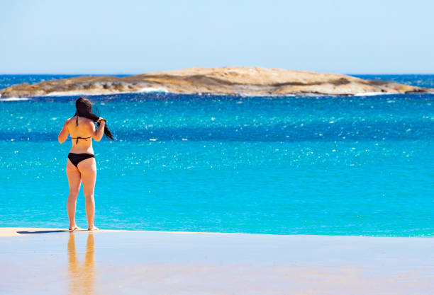 Cape Town, South Africa - February 18, 2023: Young female vacationers on Camps Bay beach
