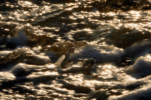 istock Sea waves at sunset. Sun glare in the waves. 1473269620