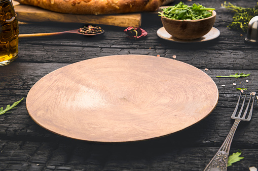 Wooden empty plate on table with space