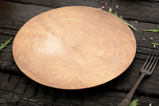 Wooden empty plate on table with space
